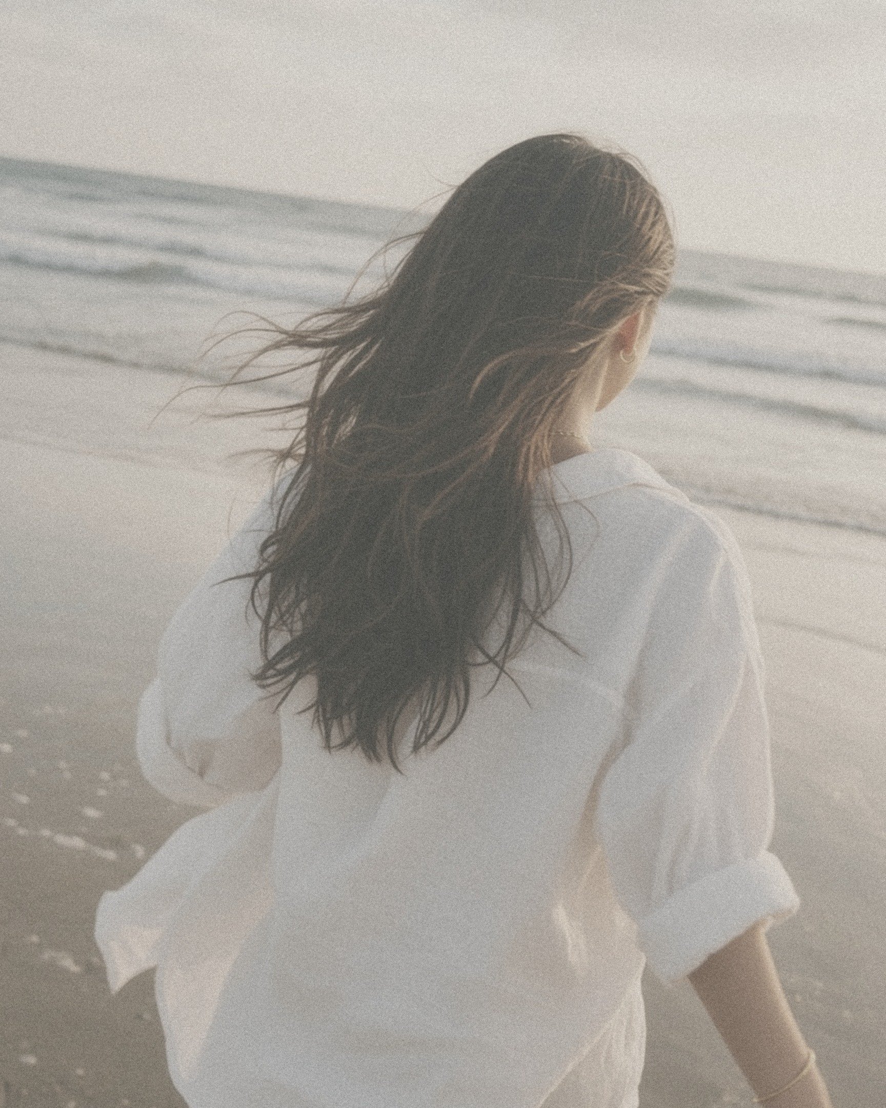 Chiara on the beach, hair in the wind